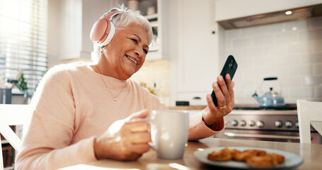 Coffee, music and elderly woman with phone in home for streaming subscription, app and entertainment. Headphones, eating and senior person with food, smile or mobile for retirement, radio and podcast