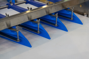 Naklejka premium Blue blades of a machine part in an industrial setting during daytime