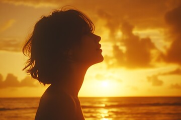 Fototapeta premium Silhouette of a woman against a vibrant sunset over the ocean at a tropical beach