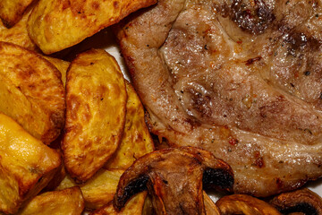 Pork steak with mushrooms and potatoes cooked in an air grill