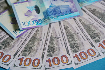 Tenge and dollar banknotes are laid out on the table.