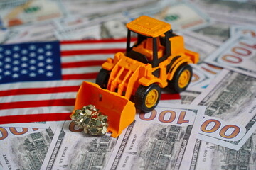 A tractor with ore on the background of the US flag And dollar bills. Mining of rare earth metals.
