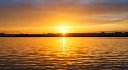 Fototapeta premium Lake Sunset Reflection with Golden Sky and Water Ripples