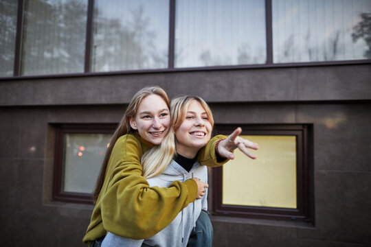 Friends enjoy time together outdoors with laughter and joy in a city setting during the day - Powered by Adobe