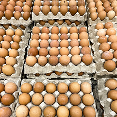pile of brown chicken eggs box displayed at market