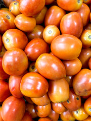 Pile of fresh tomato displayed at groceries store as food background