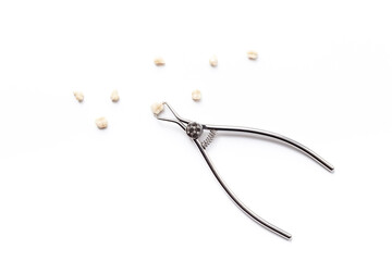 Dental steel instruments for dental prosthetics and oral treatment on a white background. Dentist desk top view