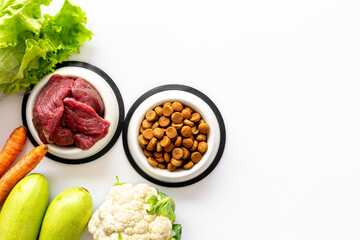 Bowls with healthy pet food and ingredients, top view