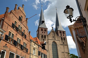 Traditional historic medieval houses, located in the neighborhood Bergkwartier of Deventer, Overijssel, Netherlands, with the two towers of Saint Nicholas church