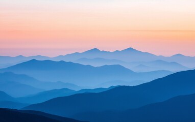 Stunning layers of blue mountains at dawn with a gentle sunrise illuminating the horizon and creating a serene atmosphere