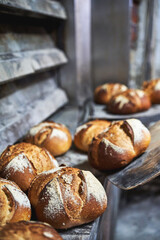Rustic artisan bread cooling on stone surface after baking