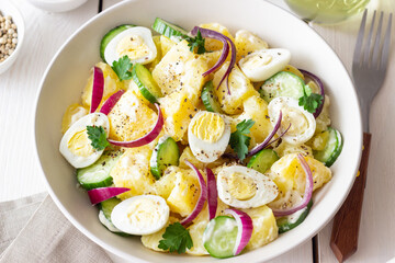 Salad with potatoes, cucumber, onion and eggs. Healthy food. Vegetarian food.
