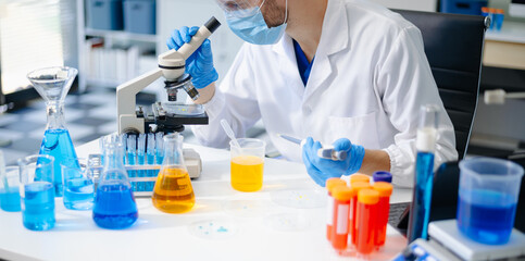 Fototapeta premium scientists in lab coats conducting research, handling glassware, and working with chemicals