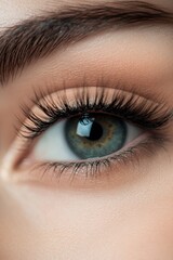 Obraz premium The Gaze of Serenity: A captivating close-up of a human eye, revealing intricate details of the iris, lashes, and the surrounding skin, offering a glimpse into profound emotions.