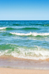 sea scenery in summer. beach with golden sand. wonderful vacation background with transparent calm waves and blue sky. wave splash