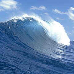 Powerful Ocean Wave Curling Under Bright Blue Sky