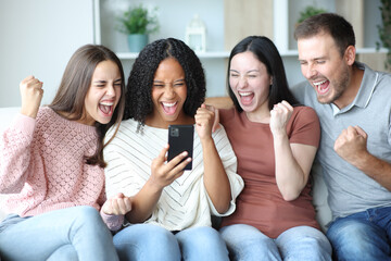 Excited group of friends watching media on phone