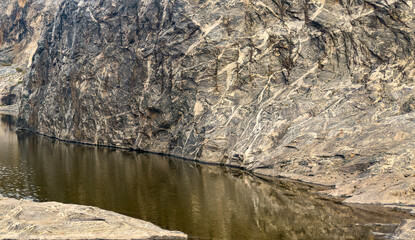 Rocky cliff beside calm water