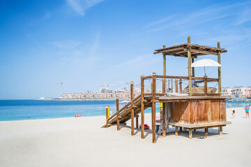 Dubai. Lifeguard tower and beach facilities at a Dubai coastal location during a sunny day.