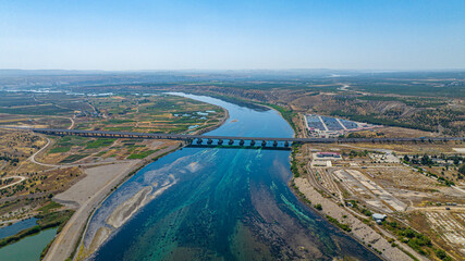 Aerial view of intercity highway bridge over a river surrounded by agricultural fields Birecik,...