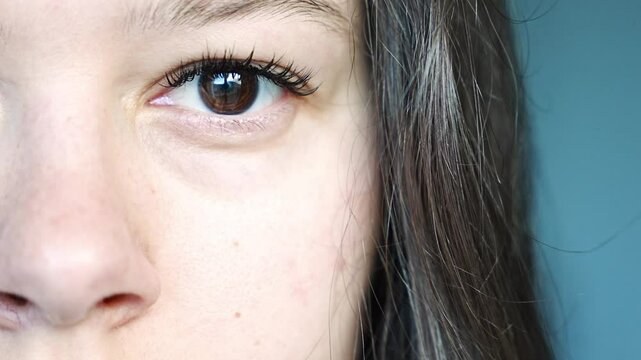 Close-up of a young woman face with an eye twitching from daily stress. A relatable moment capturing the impact of modern lifestyle on mental and physical health.