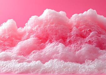 Fototapeta premium A closeup image shows pink suds and a vibrant pink background