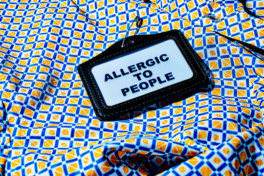 Name tag with text 'Allergic to People' on a colorful geometric shirt