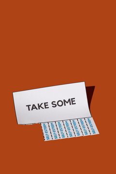 Tear-off advert with text 'Take Some' and 'Self-Esteem' on a brown background