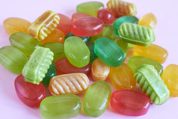 Colorful candies on a pink background, closeup of photo