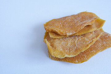 Dried mango slices on white background. Selective focus and shallow depth of field.