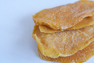Dried mango slices on white background. Close up. Selective focus.