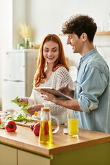Young couple sharing joy in the kitchen while preparing a delicious meal together at home
