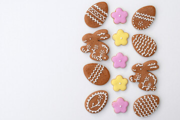Easter gingerbread cookies in a shape of egg, bunny and flowers, white background, copy space for text