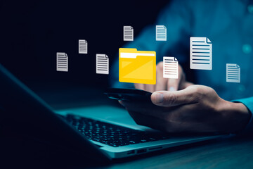 Businessman working on laptop with virtual screen. Online documentation database, IT consultant being set up Virtual Document Management System with a laptop, Software for archiving corporate files.