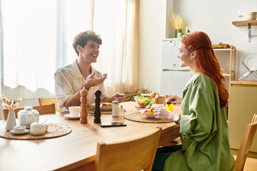 Couple enjoying a delightful meal together at home during a cozy afternoon