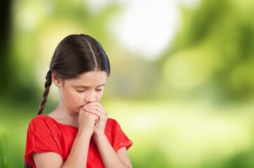 Young happy child pray, religion concept.