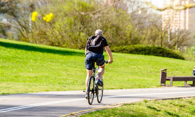 Cyclist ride on the bike path in the city Park
