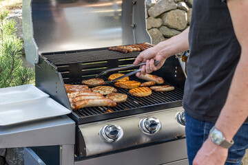 Barbecue grill bbq on propane gas grill steaks bratwurst sausages meat meal