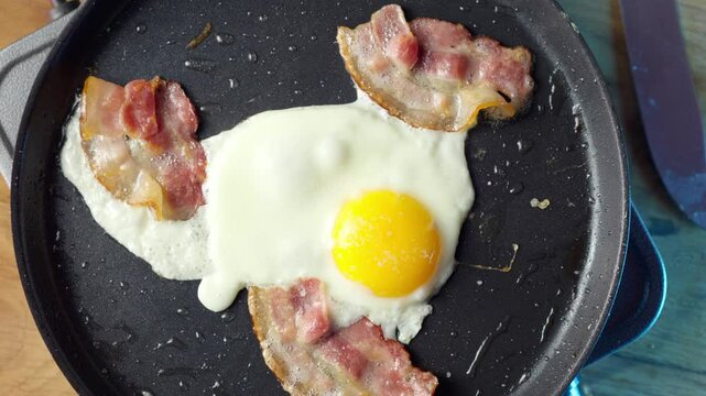 Indulge in a Delicious and Hearty Fried Egg and Bacon Breakfast to kickstart your day