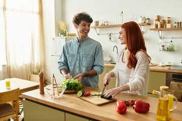 Quality moments shared by a young couple while cooking together at home in a cozy kitchen