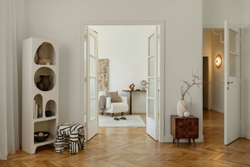 Open doorway view into a sophisticated living area with abstract art and soft tones...