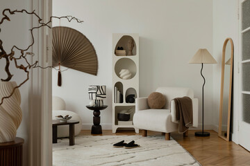 Stylish reading nook with soft textures and sculptural decor in warm neutrals...