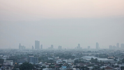 PM2.5 - Urban skyline barely visible through thick smog, highlighting severe air pollution, poor...