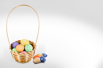 Colored Easter eggs in basket on a background.