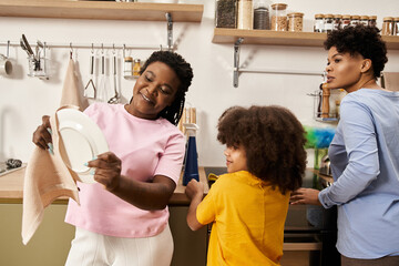 Loving family shares joyful moments while doing dishes in a cozy kitchen