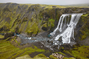 Obraz premium Fagrifoss waterfall. Mossy rocky landscape in Lakagigar. South area. Iceland