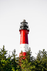View of the red and white H&ouml;rnum lighthouse in the south of the island of Sylt.
