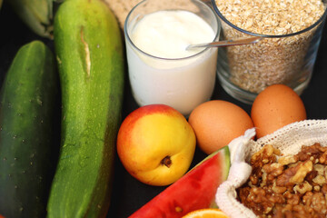 Various healthy fruits, vegetables and cereals on dark background. Selective focus.