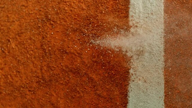 Super Slow Motion Detail Shot of Tennis Ball Hitting a Clay Court . Filmed on High Speed Cinematic Camera at 1000 fps