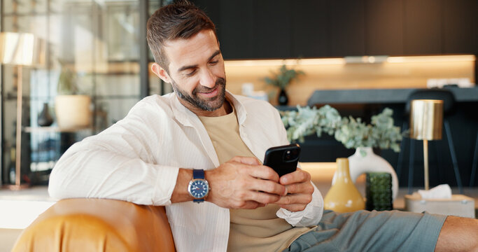 Home, relax and man on sofa, cellphone and smile with message to contact, email and connection. Person, apartment or guy on couch, smartphone and internet with funny meme, chatting or communication